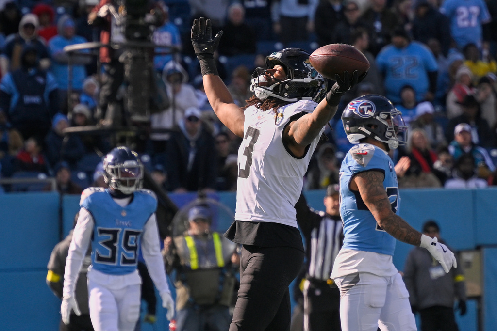 Jacksonville Jaguars wide receiver Jakobi Meyers (3) celebrates after scoring a touchdown on a pass play against the Tennessee Titans during the first half of an NFL football game Sunday, Nov. 30, 2025, in Nashville, Tenn. (AP Photo/John Amis)