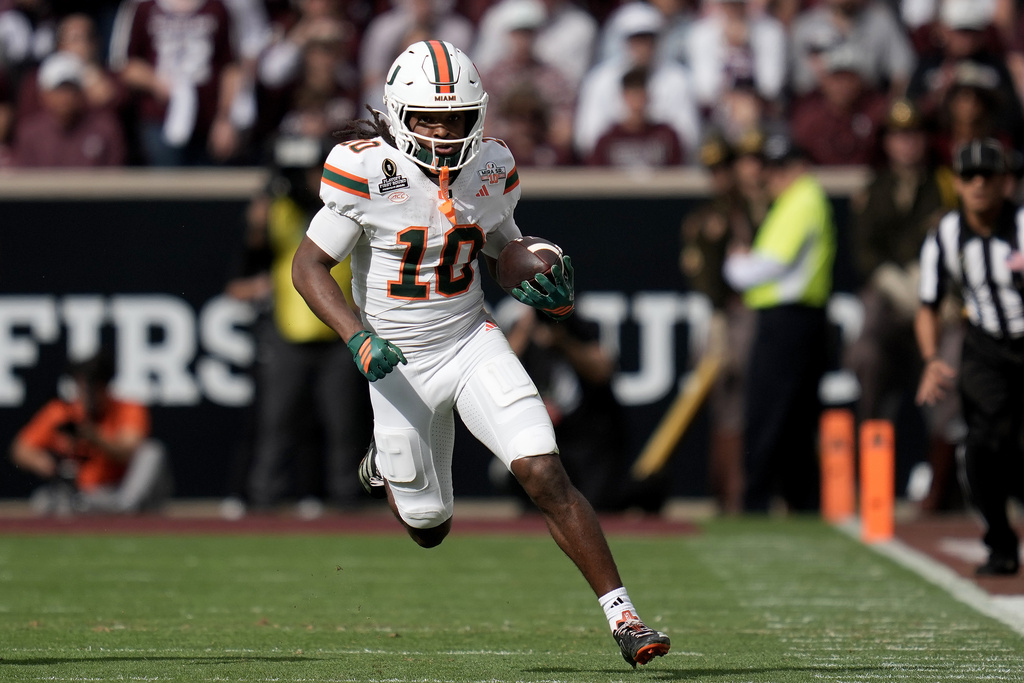 Miami wide receiver Malachi Toney (10) returns a punt against Texas A&M during the second quarter in the first round of the NCAA College Football Playoff Saturday, Dec. 20, 2025, in College Station, Texas. (AP Photo/Sam Craft)