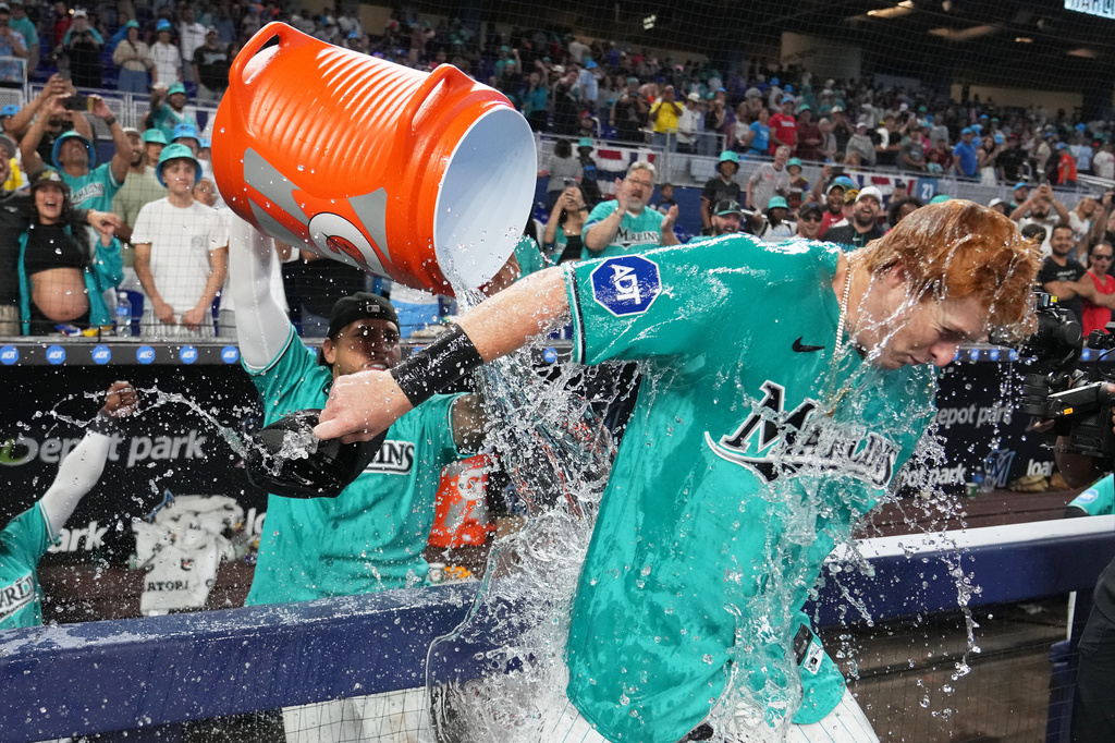 Miami Marlins' Owen Caissie, right, is doused after scoring on a walk-off two run home run to defeat the Colorado Rockies in a baseball game, Sunday, March 29, 2026, in Miami. (AP Photo/Lynne Sladky)