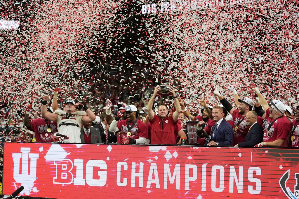 Indiana head coach Curt Cignetti holds the cahampionship trophy after the Big Ten championship NCAA college football game against Ohio State in Indianapolis, Saturday, Dec. 6, 2025. (AP Photo/Michael Conroy)