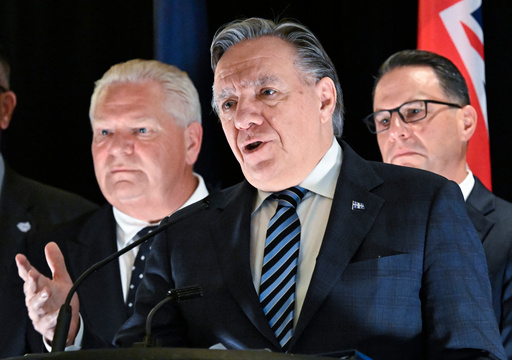 Ontario Premier Doug Ford, left, and Pennsylvania Governor Josh Shapiro, right, look on as Quebec Premier Francois Legault speaks at a news conference at the end of the Great Lakes and St.Lawrence Governors & Premiers meeting in Quebec City, Quebec, Monday, Oct. 6, 2025. (Jacques Boissinot/The Canadian Press via AP) Ontario Premier Doug Ford, left, and Pennsylvania Governor Josh Shapiro, right, look on as Quebec Premier Francois Legault speaks at a news conference at the end of the Great Lakes and St.Lawrence Governors & Premiers meeting in Quebec City, Quebec, Monday, Oct. 6, 2025. (Jacques Boissinot/The Canadian Press via AP)