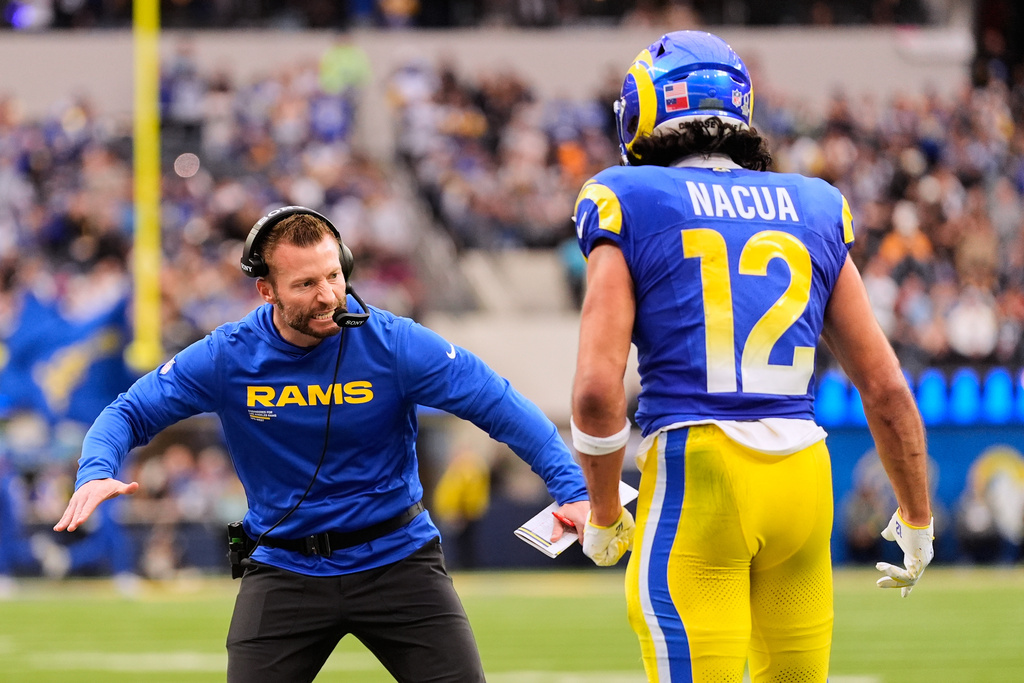 Los Angeles Rams wide receiver Puka Nacua (12) celebrates with head coach Sean McVay after his touchdown during the first half of an NFL football game against the Arizona Cardinals, Sunday, Jan. 4, 2026, in Inglewood, Calif. (AP Photo/Mark J. Terrill)