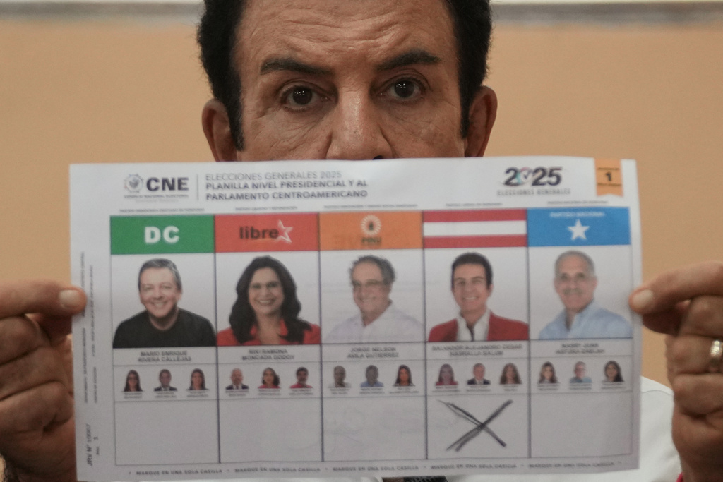 Presidential candidate Salvador Nasralla, of the Liberal Party, shows his ballot during general elections in Tegucigalpa, Honduras, Sunday, Nov. 30, 2025. (AP Photo/Moises Castillo)