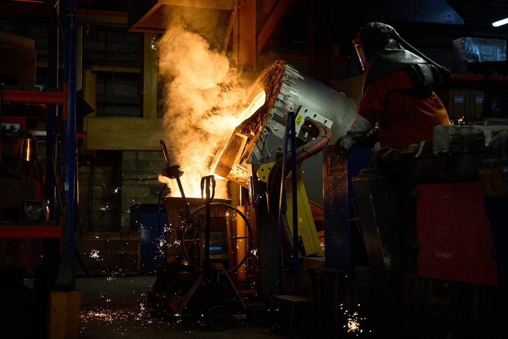 A furnace worker pour molten metal as part of the process to create BAFTA masks at FSE Foundry in Braintree, England on Tuesday, Feb. 10, 2026. (Scott A Garfitt/Invision/AP)