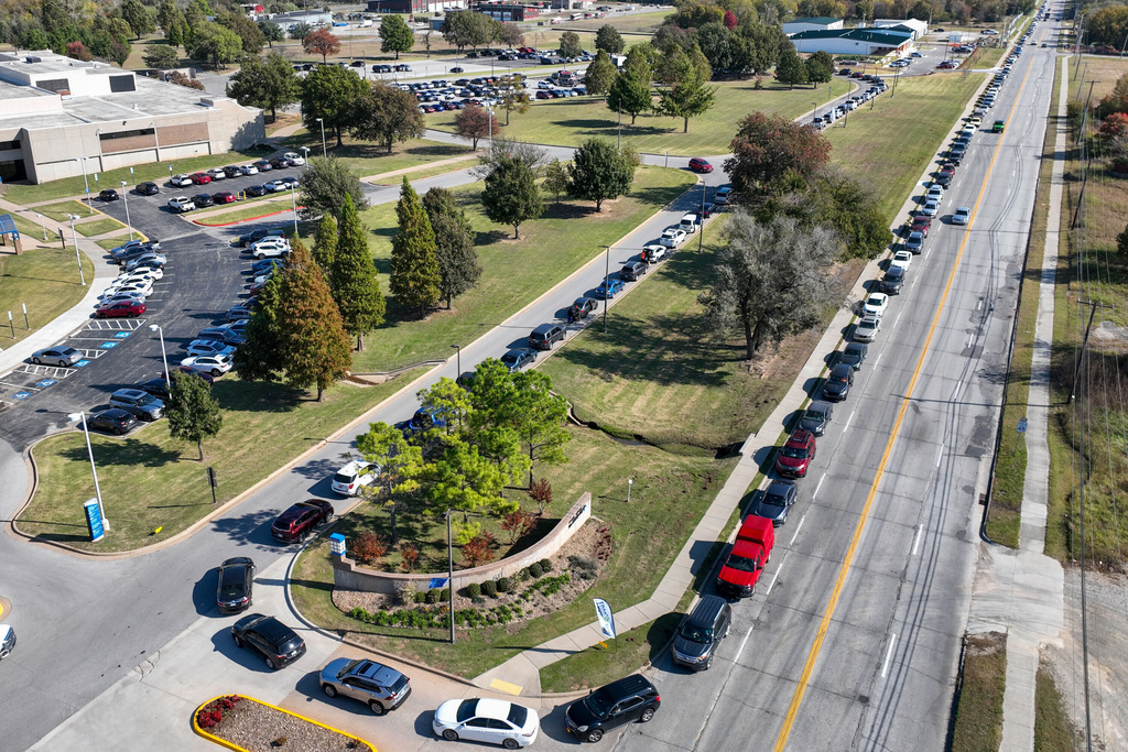 Cars line up for a pop-up food distribution event to provide extra support for Tulsa families affected by the recent lapse in SNAP benefits, at Food on the Move in Tulsa, Okla., on Thursday, Nov. 6, 2025. (Mike Simons/Tulsa World via AP)
