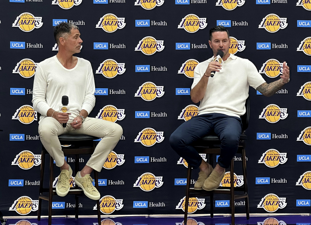 Los Angeles Lakers general manager Rob Pelinka, left and head coach JJ Redick speak with reporters in a news conference at the Lakers' training complex in El Segundo, Calif., on Thursday, Sept. 24, 2026. (AP Photo/Greg Beacham)