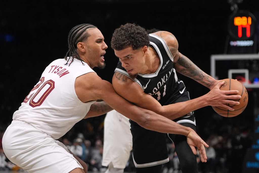 Cleveland Cavaliers' Jaylon Tyson (20) defends Brooklyn Nets' Michael Porter Jr. (17) during the second half of an NBA basketball game Friday, Oct. 24, 2025, at Barclays Center in New York. (AP Photo/Frank Franklin II)