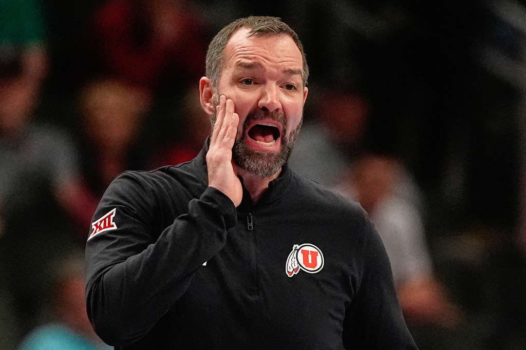 FILE - Utah head coach Alex Jensen talks to his players during the first half of an NCAA college basketball game against Cincinnati at the Big 12 Conference tournament, March 10, 2026, in Kansas City, Mo. (AP Photo/Charlie Riedel, File)