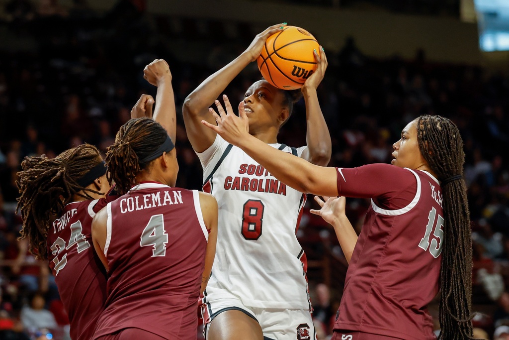 South Carolina forward Joyce Edwards (8) drives to the basket against North Carolina Central forward Aniya Finger (24), guard Tierney Coleman (4) and forward Dianna Blake (15) during the first half of an NCAA college basketball game in Columbia, S.C., Sunday, Dec. 7, 2025. (AP Photo/Nell Redmond)