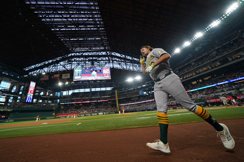 Athletics' Nick Kurtz runs to the dugout after hitting a leadoff home run on the first pitch from Texas Rangers starting pitcher Nathan Eovaldi during the first inning of a baseball game Friday, April 24, 2026, in Arlington, Texas. (AP Photo/Julio Cortez)