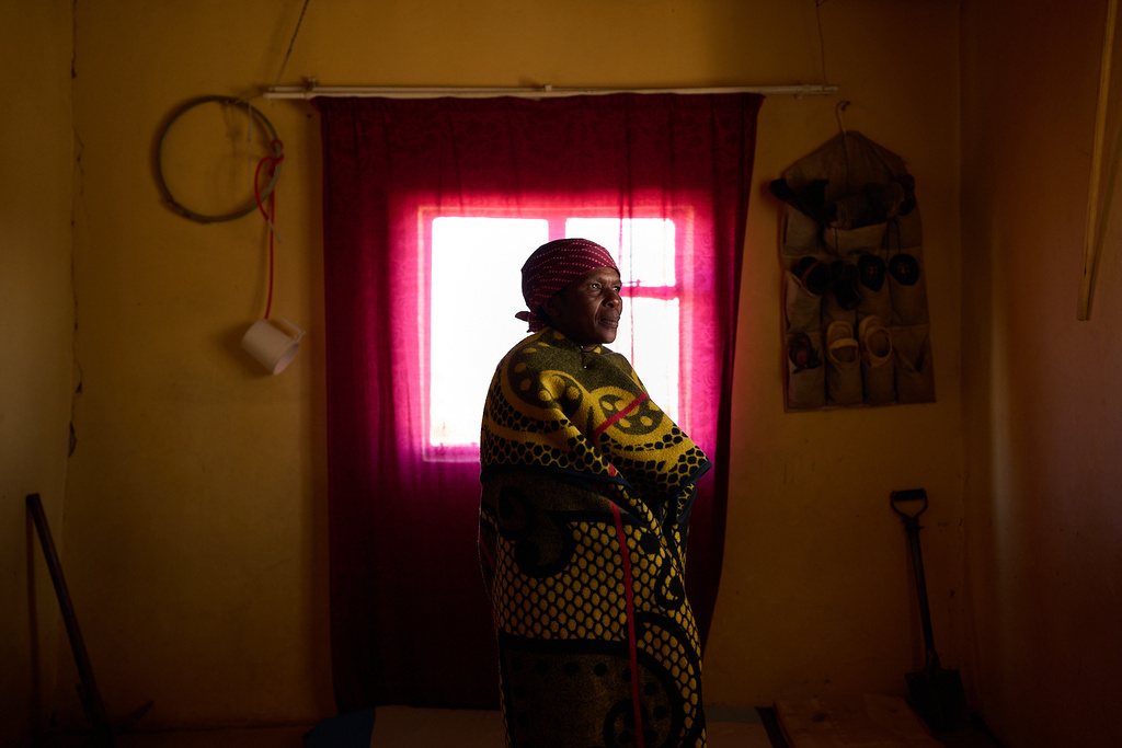 Mateboho Talitha Fusi, who is HIV-positive, poses for a portrait in Ha Koloboi, Lesotho, Saturday, July 12, 2025. Fusi is part of a peer-support group in her village, a concept that came about with U.S.-funded programs to help communities and residents live with HIV and support each other during lifelong treatments. Fusi still has access to her medication, but since the aid cuts, she'd been receiving fewer pills in each refill, causing worry for the future. (AP Photo/Bram Janssen)