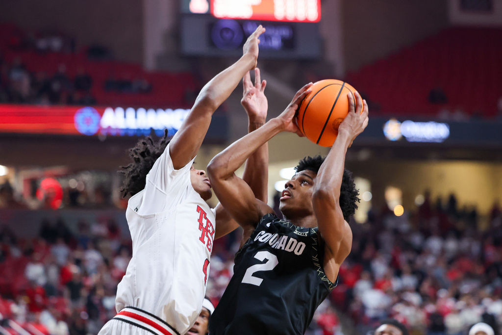 Colorado guard Isaiah Johnson (2) shoots the ball over Texas Tech guard Christian Anderson during the first half of an NCAA college basketball game, Wednesday, Feb. 11, 2026, in Lubbock, Texas. (AP Photo/Chase Seabolt)