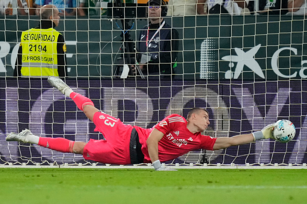 Real Madrid's goalkeeper Andriy Lunin saves during a La Liga soccer match between Real Betis and Real Madrid in Seville, Spain, Friday, April 24, 2026. (AP Photo/Jose Breton)