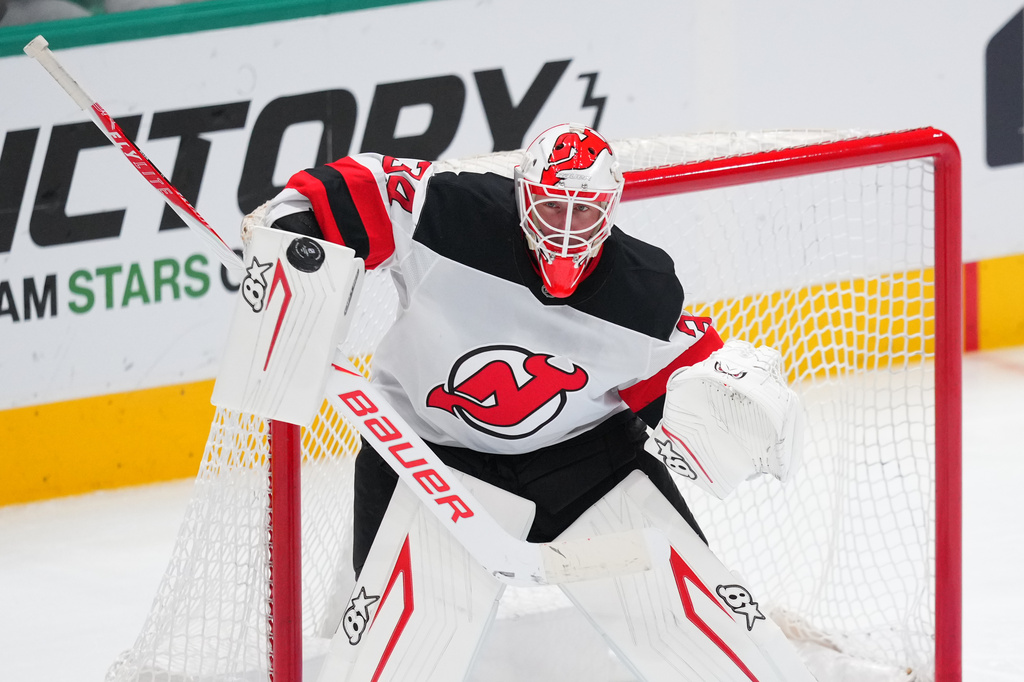 FILE - New Jersey Devils goaltender Jake Allen (34) guards his net during the third period of an NHL hockey game between the Dallas Stars and the New Jersey Devils, Tuesday, March 24, 2026, in Dallas. (AP Photo/Julio Cortez, file)