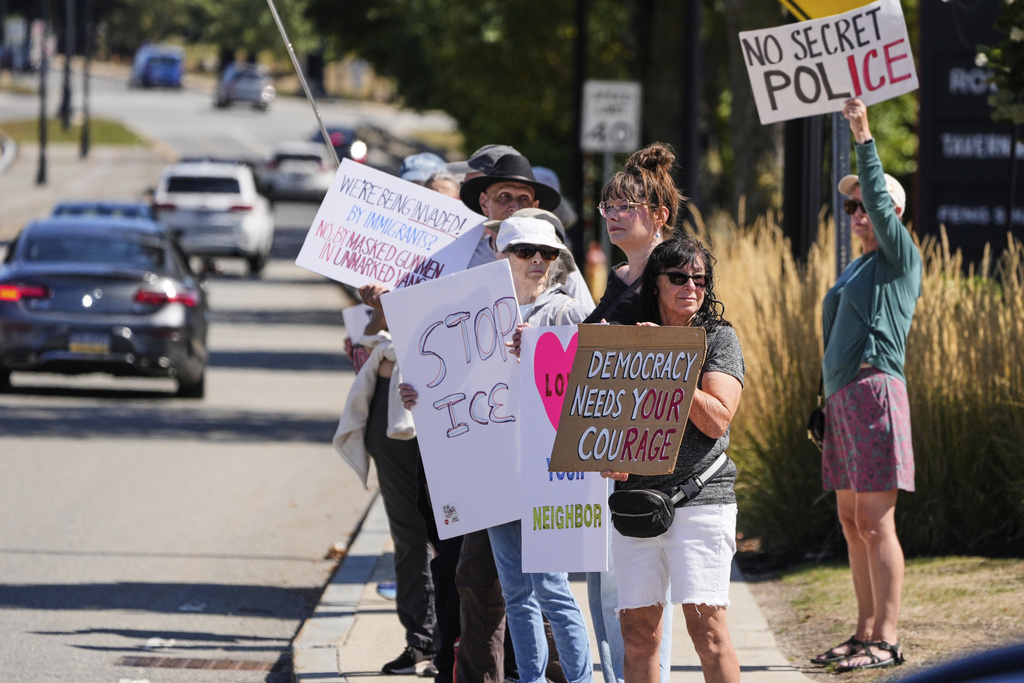 Protesters picket near the U.S. Immigration and Customs Enforcement regional field office, Thursday, Sept. 11, 2025, in Burlington, Mass. (AP Photo/Charles Krupa)