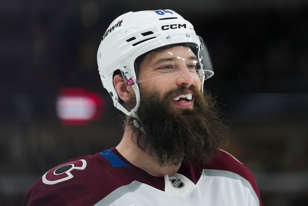 Colorado Avalanche defenseman Brent Burns (84) smiles at his teammates at the end of the first period of an NHL hockey game against the Chicago Blackhawks, Friday, March 20, 2026, in Chicago. (AP Photo/Erin Hooley)