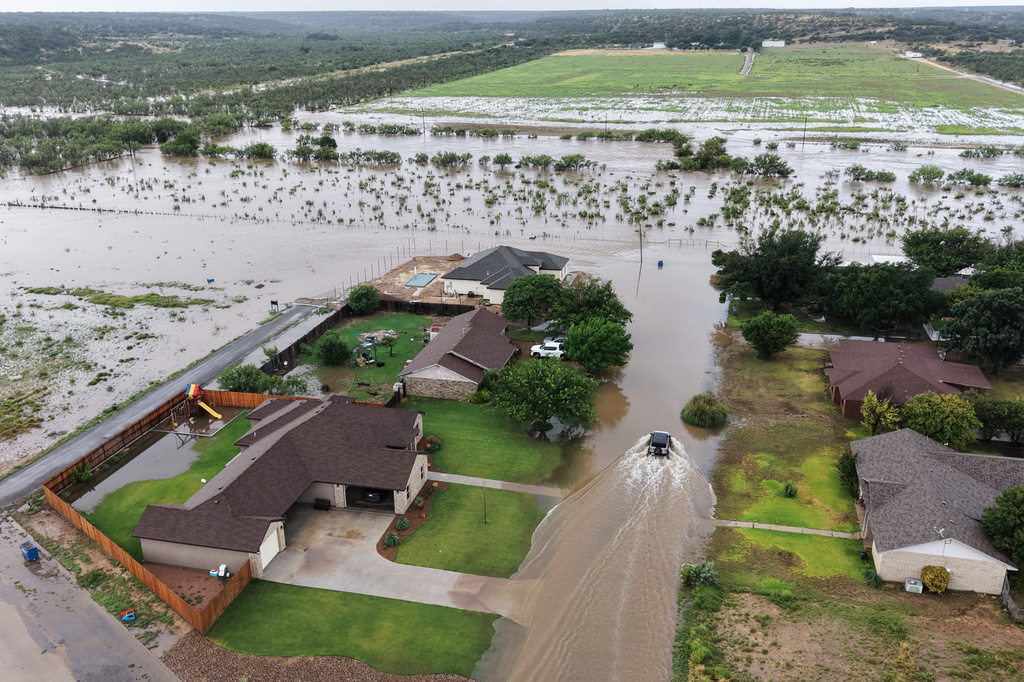 An aerial view shows flooding on Friday, July 17, 2026, in Ozona, Texas. (AP Photo/Gerald Herbert)