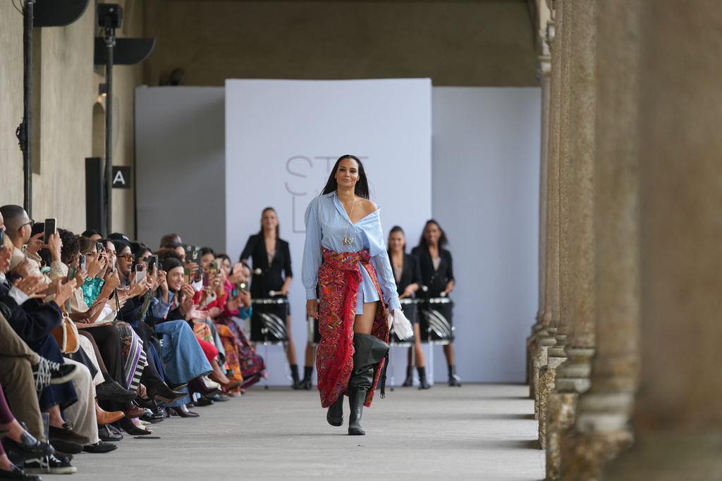 Fashion designer Stella Jean walks the runway at the end of her Spring/Summer 2026 collection during Milan Fashion Week in Milan, Italy, Saturday, Sept. 27, 2025. (AP Photo/Antonio Calanni)