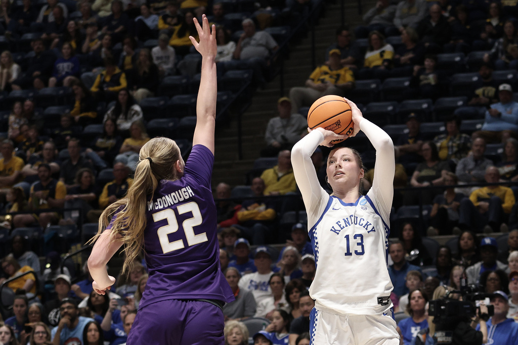 Kentucky center Clara Strack (13) shoots over James Madison forward Grace McDonough (22) in the second half in the first round of the NCAA college basketball tournament, Saturday, March 21, 2026, in Morgantown, W.Va. (AP Photo/Kathleen Batten)