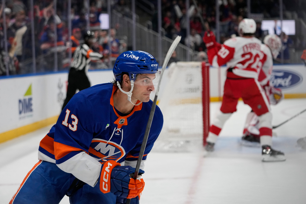 New York Islanders' Mathew Barzal (13) looks for his teammates after scoring a goal as Detroit Red Wings' Albert Johansson (20) and goaltender Cam Talbot (39) react during the second period of an NHL hockey game Thursday, Oct. 23, 2025, at UBS Arena in Elmont, N.Y. (AP Photo/Frank Franklin II)
