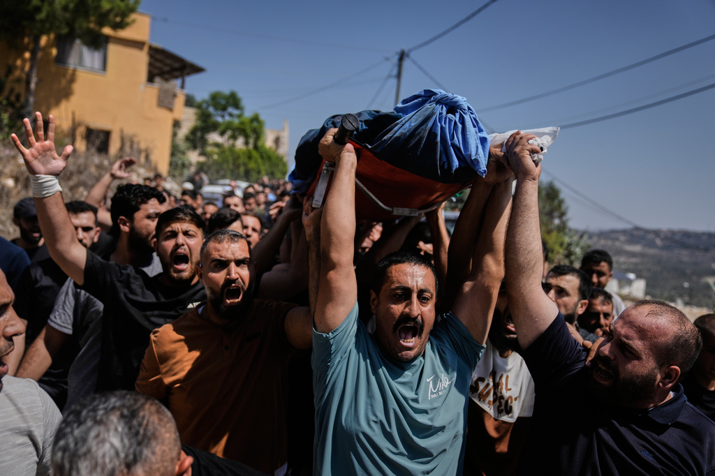 Mourners carry the body of Palestinian Omar al-Toubasi who was killed during clashes with Israeli army soldiers last night, during his funeral in the West Bank village Hajja, Monday, Sept. 7, 2026. (AP Photo/Majdi Mohammed)