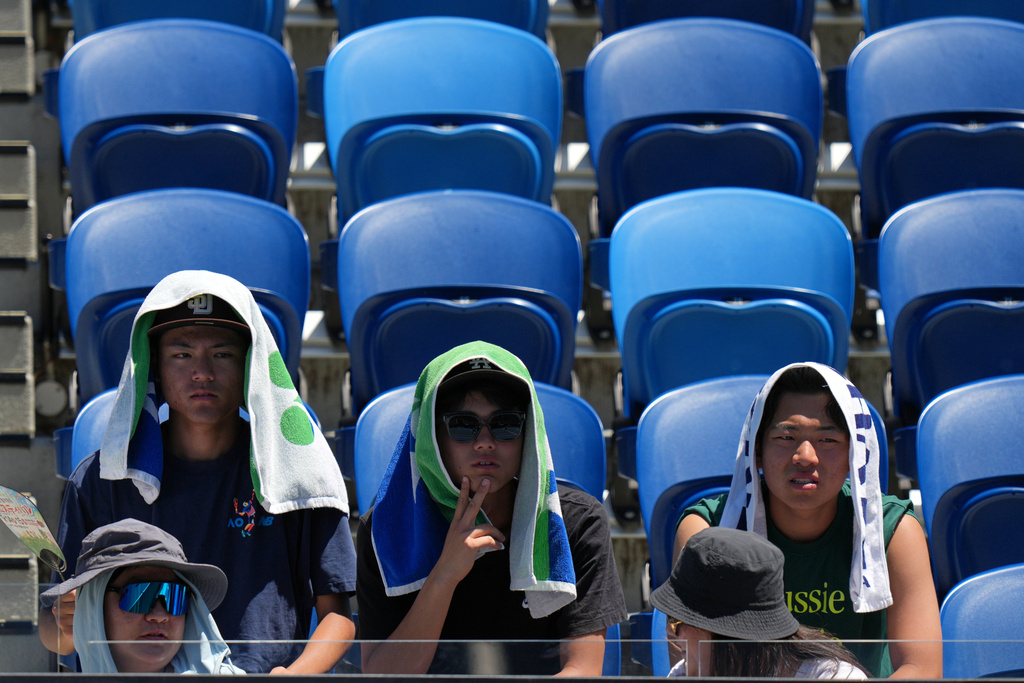 Spectators watch third round matches at the Australian Open tennis championship in Melbourne, Australia, Saturday, Jan. 24, 2026. (AP Photo/Dar Yasin)
