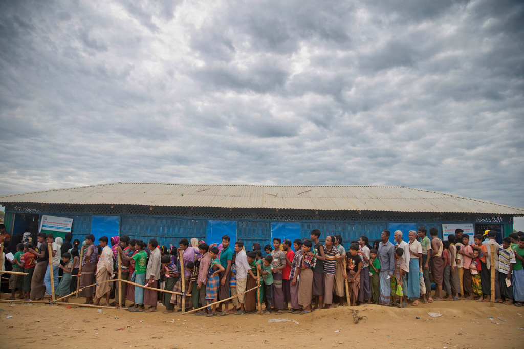 FILE -Rohingya Muslims, who crossed over from Myanmar into Bangladesh, wait in queues to receive aid at Kutupalong refugee camp in Ukhiya, Bangladesh, Nov. 15, 2017. (AP Photo/A.M. Ahad, File)