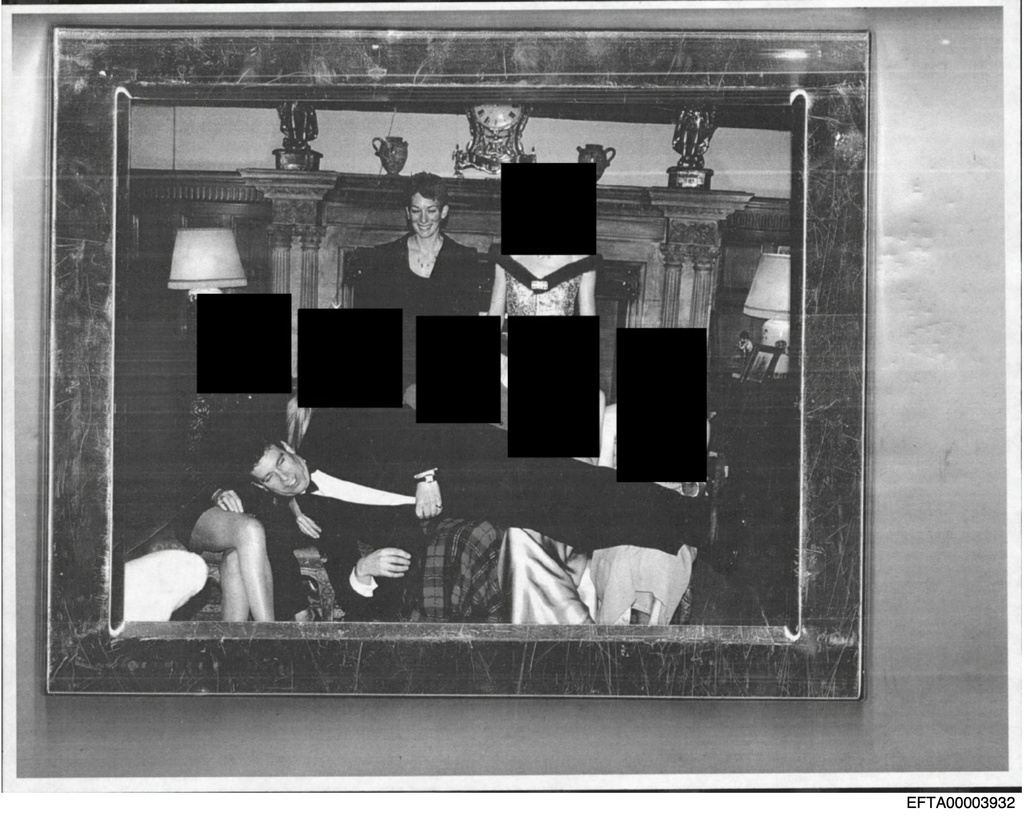 This redacted photo released by the U.S. Department of Justice shows Andrew Mountbatten-Windsor laying across several people's laps with Ghislaine Maxwell standing above. (U.S. Department of Justice via AP)