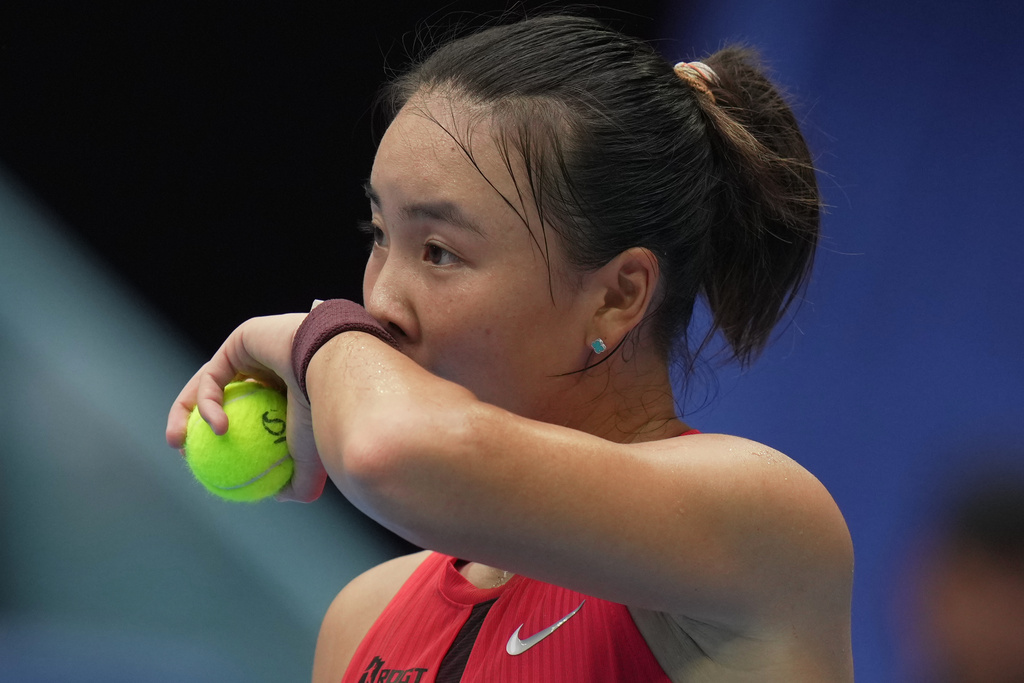 Yuan Yue, of China wipes sweat as she preparing to serve against Iga Swiatek, of Poland during the women's singles match for the China Open tennis tournament, at the National Tennis Center, in Beijing, Saturday, Sept. 27, 2025. (AP Photo/Andy Wong)