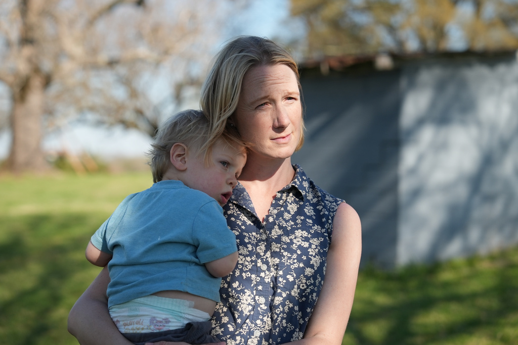 Helen Kaiser holds her son at their home in Landrum, S.C., on March 19, 2026. (AP Photo/Mary Conlon)
