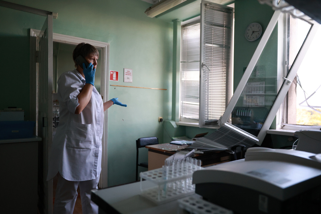 A medic speaks on the phone inside a hospital damaged in a Russian drone strike in Zaporizhzhia, Ukraine, Friday, Sept. 25, 2026. (AP Photo/Kateryna Klochko)