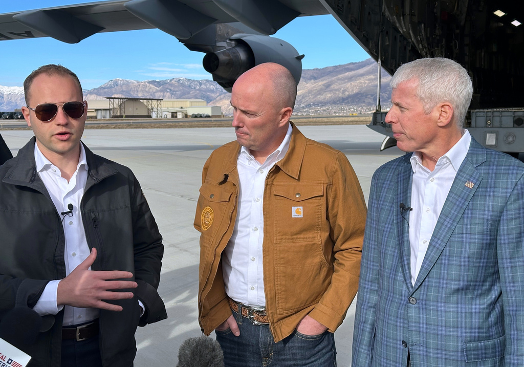 Isaiah Taylor, CEO of Valar Atomics, left, speaks as Utah Gov. Spencer Cox, center, and Energy Secretary Chris Wright, listen, at Hill Air Force Base, Utah, Sunday, Feb. 15, 2026. (AP Photo/Matthew Daly)
