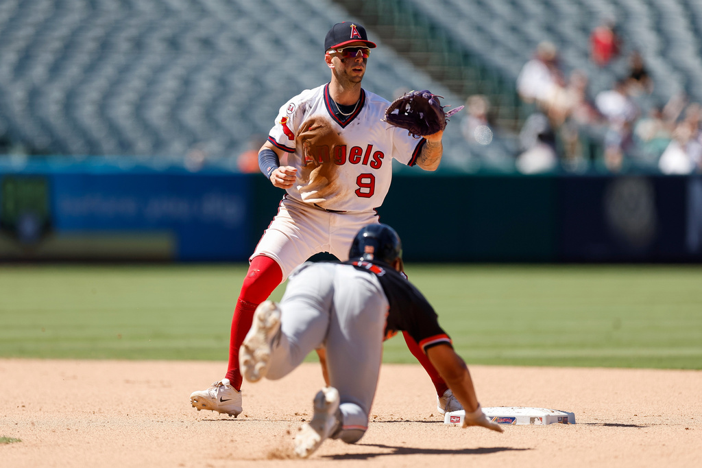 Los Angeles Angels shortstop Zach Neto (9) waits to catch the ball as Detroit Tigers' Hao-Yu Lee, bottom, slides toward second base during the seventh inning of a baseball game Sunday, July 19, 2026, in Anaheim, Calif. (AP Photo/Caroline Brehman)