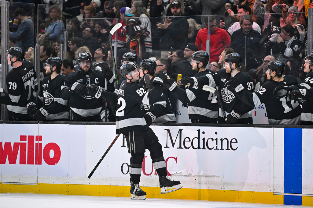 Los Angeles Kings defenseman Brandt Clarke (92) celebrates with teammates after scoring during the first period of an NHL hockey game against the Anaheim Ducks, Saturday, Dec. 27, 2025, in Los Angeles. (AP Photo/Katie Chin)
