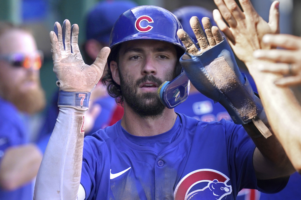 Chicago Cubs' Dansby Swanson celebrates in the dugout after scoring during the sixth inning of a baseball game against the Pittsburgh Pirates, Wednesday, Sept. 17, 2025, in Pittsburgh. (AP Photo/Matt Freed)