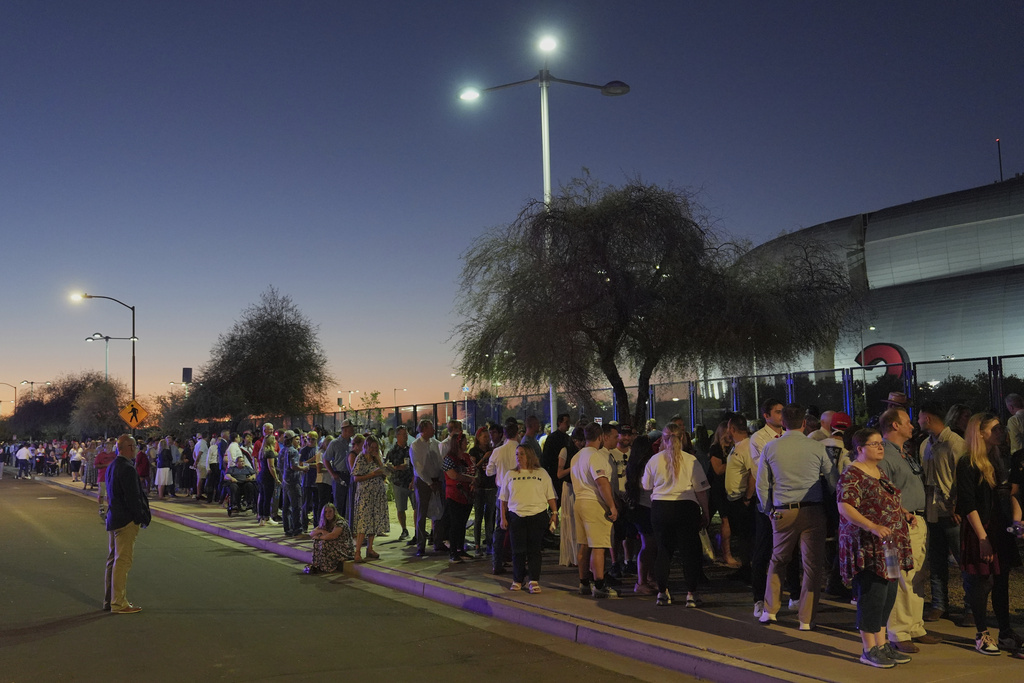 People wait in line before a memorial for conservative activist Charlie Kirk Sunday, Sept. 21, 2025, at State Farm Stadium in Glendale, Ariz. (AP Photo/Jae C. Hong)