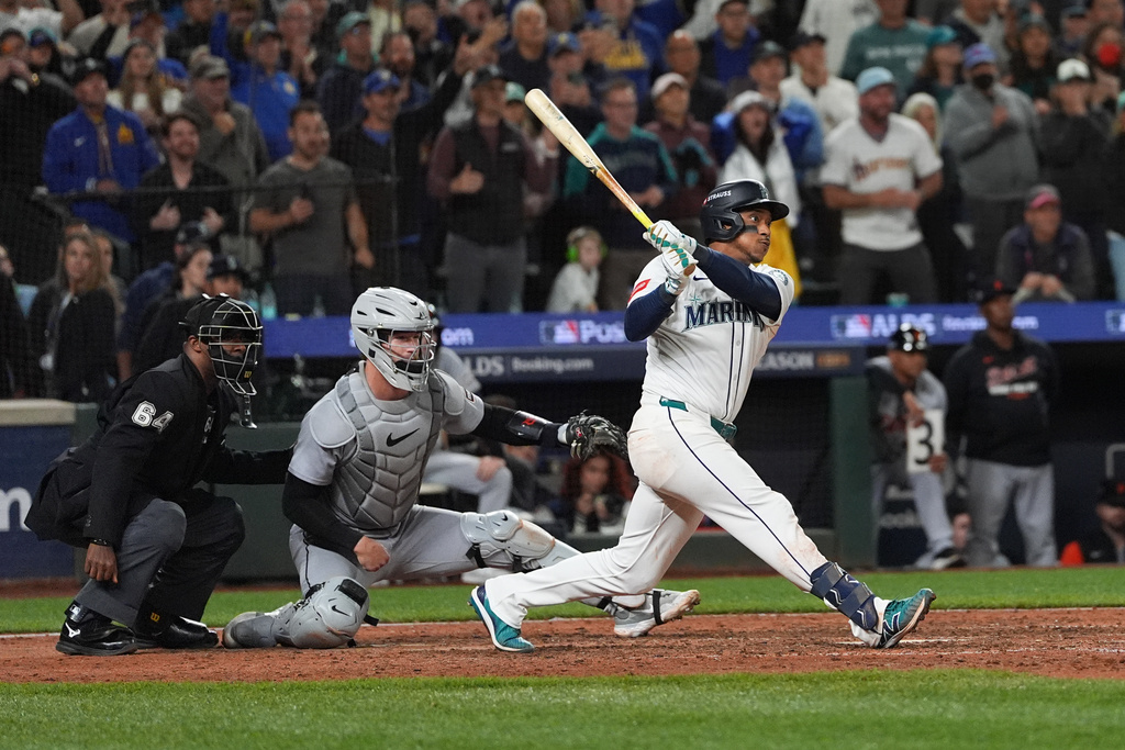 Seattle Mariners' Jorge Polanco hits an RBI-single for J.P. Crawford to score the game-winning run during the 15th inning in Game 5 of baseball's American League Division Series against the Detroit Tigers, Friday, Oct. 10, 2025, in Seattle. (AP Photo/Lindsey Wasson)