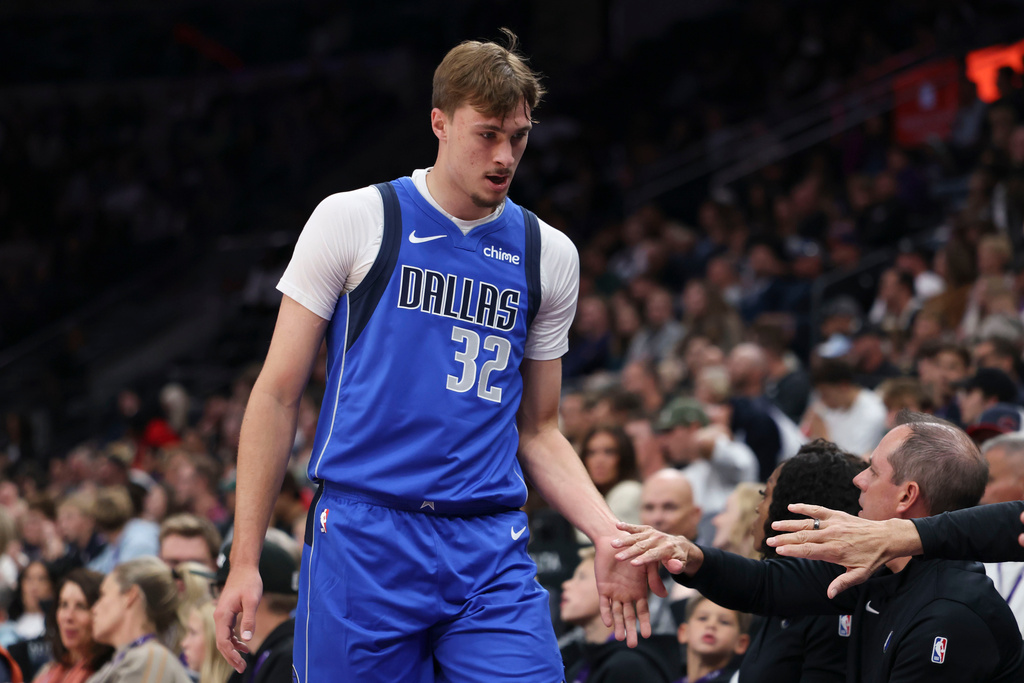 Dallas Mavericks forward Cooper Flagg (32) slaps hands during the first half of a preseason NBA basketball game against the Utah Jazz, Monday, Oct. 13, 2025, in Salt Lake City. (AP Photo/Rob Gray)