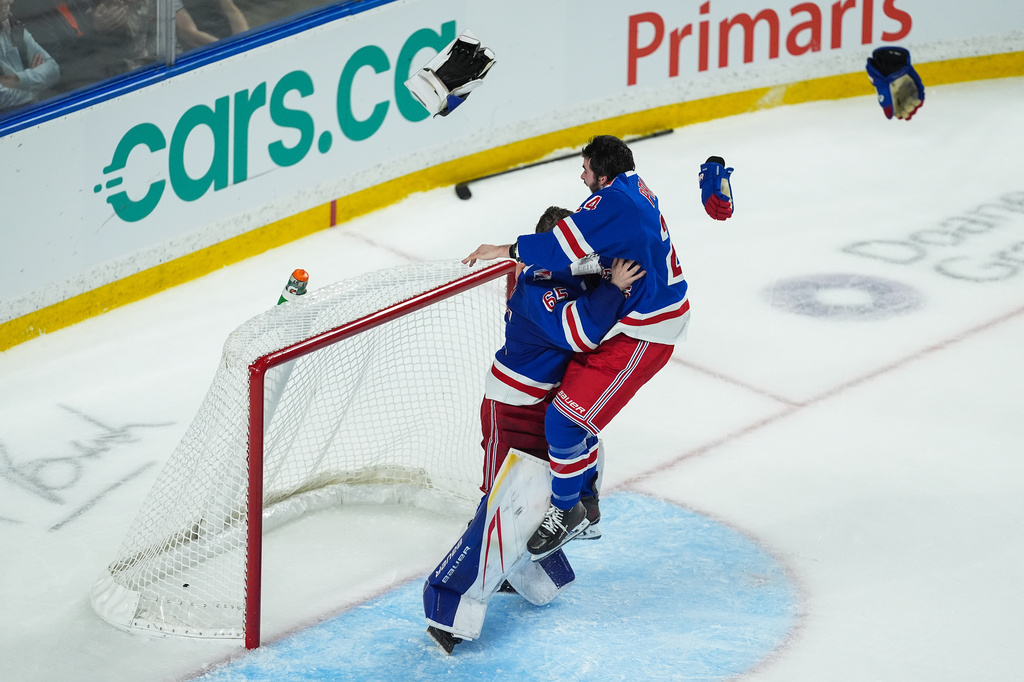 Kitchener Rangers' Jack Pridham, right, leaps into the arms of goalie Christian Kirsch as they celebrate after Kitchener defeated the Everett Silvertips to win the Memorial Cup final hockey game in Kelowna, British Columbia, on Sunday, May 31, 2026. (Darryl Dyck/The Canadian Press via AP)
