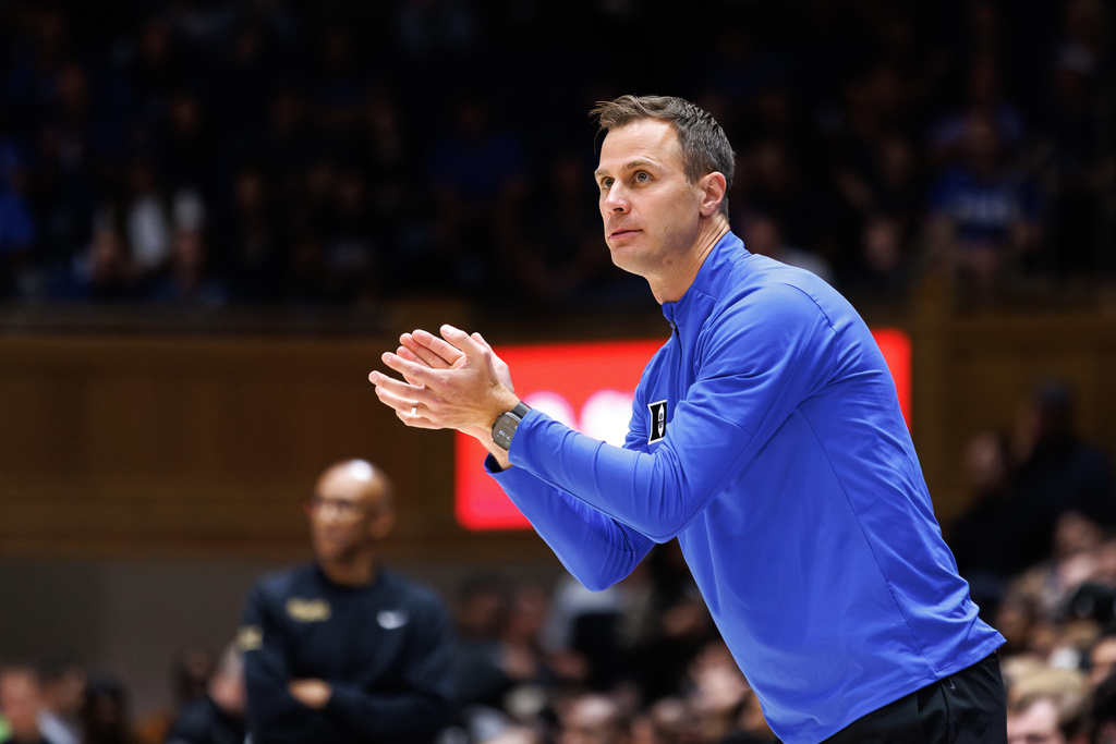 FILE - Duke head coach Jon Scheyer claps for his team during the first half of an NCAA college basketball game against Central Florida in Durham, N.C., Tuesday, Oct. 21, 2025. (AP Photo/Ben McKeown, File)