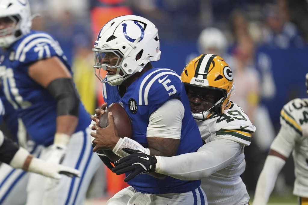 Indianapolis Colts quarterback Anthony Richardson Sr. (5) is sacked by Green Bay Packers defensive end Deslin Alexandre (49) during the first half of a preseason NFL football game, Saturday, Aug. 16, 2025, in Indianapolis. (AP Photo/Michael Conroy)