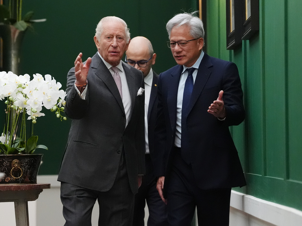 Britain's King Charles III, left, walks with Nvidia chief executive Jensen Huang, right, and Sir Demis Hassabis to a meeting for leaders from the artificial intelligence (AI) sector, government, and thought leaders to discuss how AI can be developed and deployed in ways that benefit society, at Dumfries House in Cumnock, Scotland, Thursday Sept. 17, 2026. (Jonathan Brady/PA via AP, Pool)