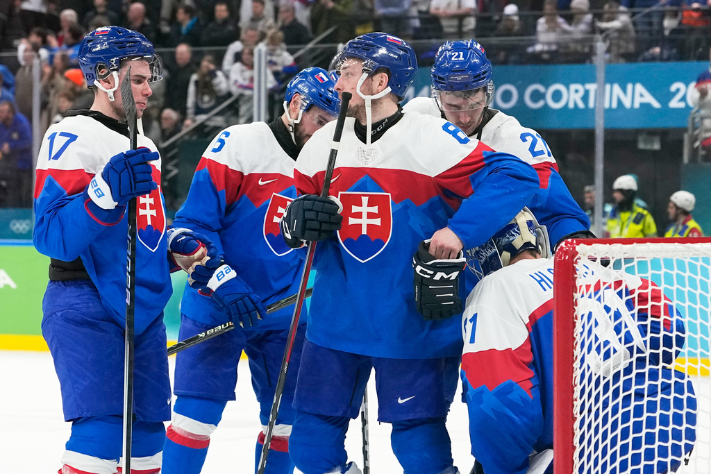 Slovakia players are dejected at the end of a men's ice hockey bronze medal game between Slovakia and Finland at the 2026 Winter Olympics, in Milan, Italy, Saturday, Feb. 21, 2026. (AP Photo/Hassan Ammar)