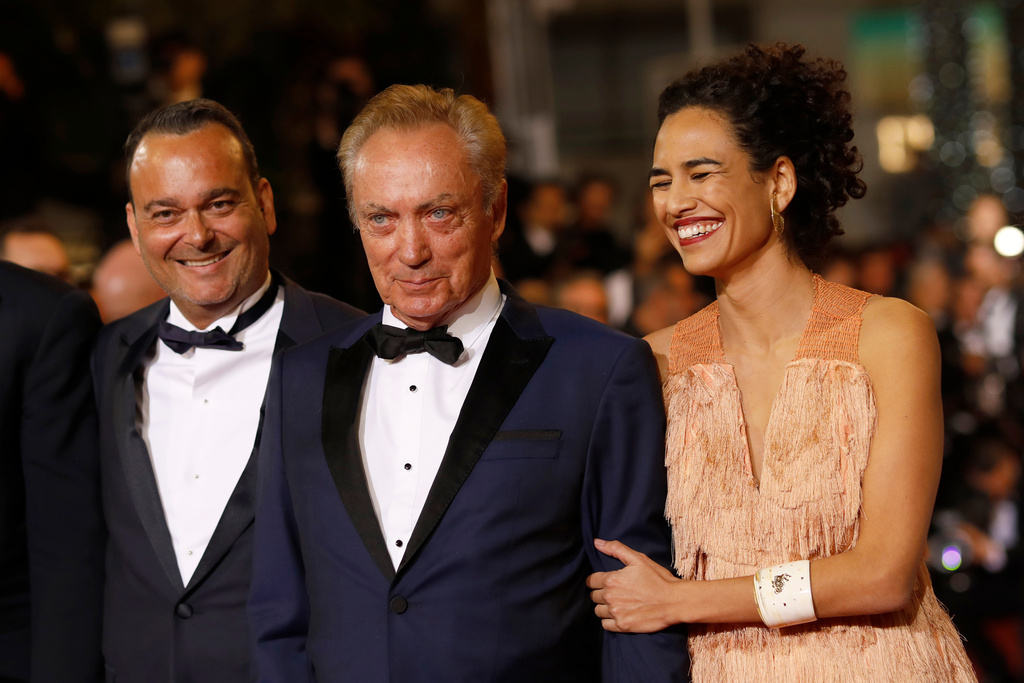FILE - Actors Udo Kier, centre, and Babara Colen, right, pose for photographers upon arrival at the premiere of the film 'Bacurau' at the 72nd international film festival, Cannes, southern France, May 15, 2019. (AP Photo/Petros Giannakouris, File)