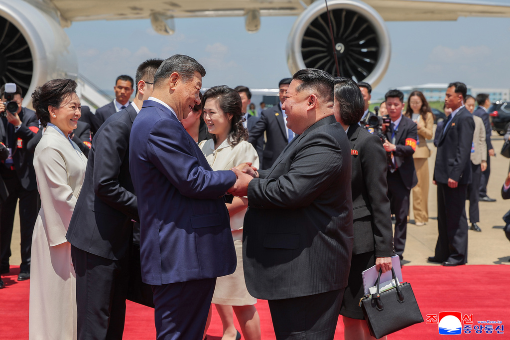 In this photo provided by the North Korean government, North Korean leader Kim Jong Un, front right, shakes hands with Chinese President Xi Jinping, front left, on the latter's arrival at the airport in Pyongyang, Monday, June 8, 2026. Independent journalists were not given access to cover the event depicted in this image distributed by the North Korean government. The content of this image is as provided and cannot be independently verified. Korean language watermark on image as provided by source reads: "KCNA" which is the abbreviation for Korean Central News Agency. (Korean Central News Agency/Korea News Service via AP)