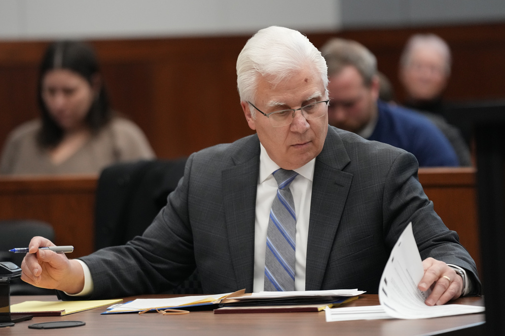 Michigan football coach Sherrone Moore's attorney Joseph A. Simon looks over papers in court on Friday, Dec. 12, 2025 in Ann Arbor, Mich. (AP Photo/Ryan Sun, Pool)