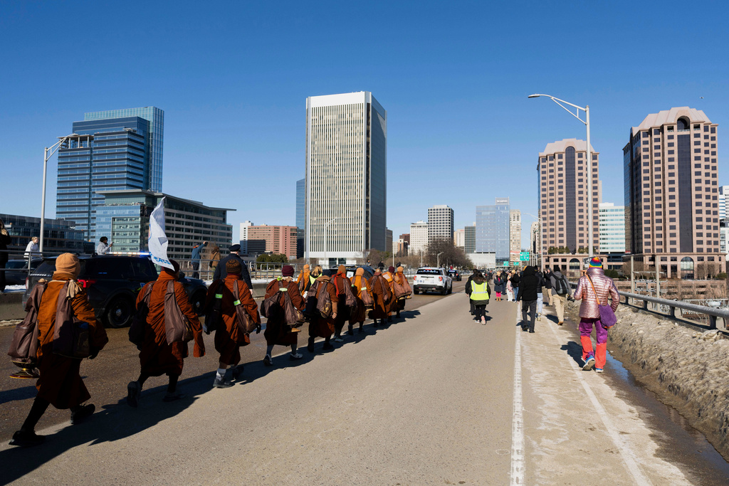 Venerable Buddhist monks cross the 9th Street bridge during a walk for peace into downtown Richmond, Va., Monday, Feb. 2, 2026. (Mike Kropf/Richmond Times-Dispatch via AP)