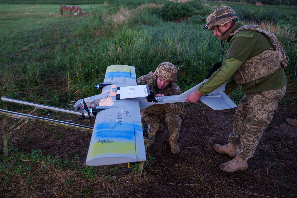 Ukrainian servicemen of K-2 brigade of the Unmanned Systems Forces prepare a midrange drone at takeoff position before flying towards Russian positions at the frontline in Donetsk region, Ukraine, Monday, June 22, 2026. (AP Photo/Evgeniy Maloletka)