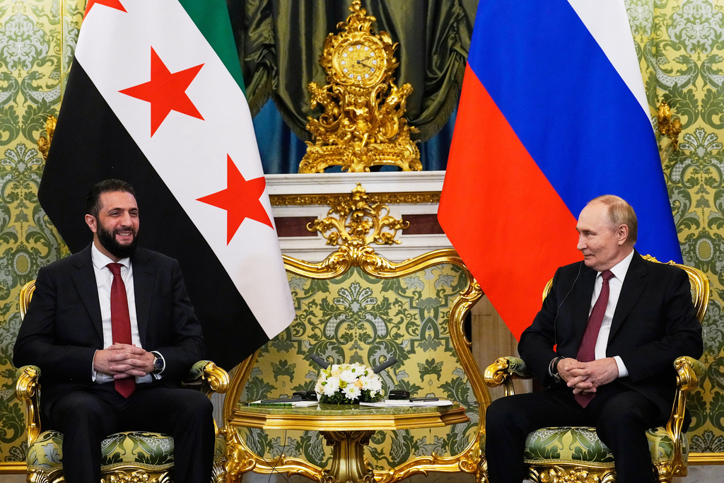 Russian President Vladimir Putin, right, and Syrian interim President Ahmad al-Sharaa talk during their meeting at the Grand Kremlin Palace in Moscow, Russia, Wednesday, Oct. 15, 2025. (AP Photo/Alexander Zemlianichenko, Pool)