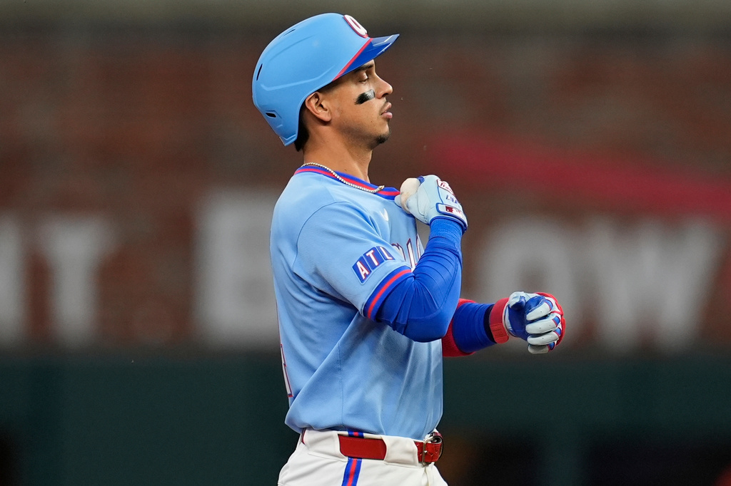 Atlanta Braves' Mauricio Dubón (14) celebrates his RBI-double against the Cleveland Guardians in the second inning of a baseball game, Sunday, April 12, 2026, in Atlanta. (AP Photo/Mike Stewart)